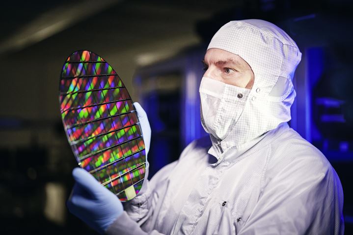 Man assesses semiconductor wafer 